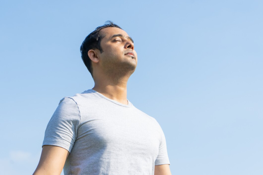 man practicing breathing exercise